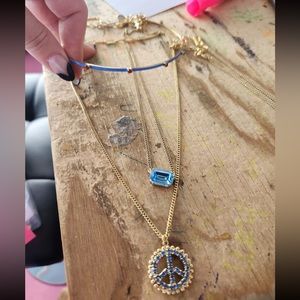 TOVA Peace out sapphire blue crystal on a chain